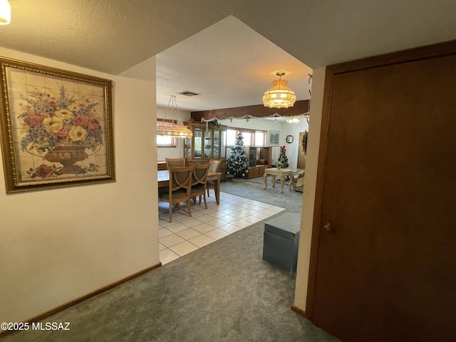 11985 N Cayce Ln, Casa Grande, AZ 85194 - hall featuring a chandelier, light carpet, baseboards, and light tile patterned flooring