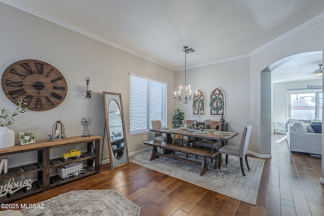983 N Via Zahara Del Sol, Tucson, AZ 85748 - dining space with arched walkways, hardwood / wood-style flooring, baseboards, crown molding, and a chandelier