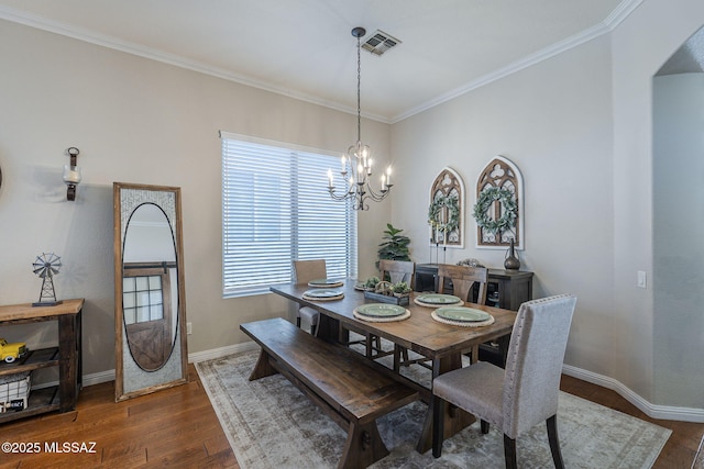 983 N Via Zahara Del Sol, Tucson, AZ 85748 - dining space featuring dark wood-type flooring, a chandelier, baseboards, crown molding, and arched walkways
