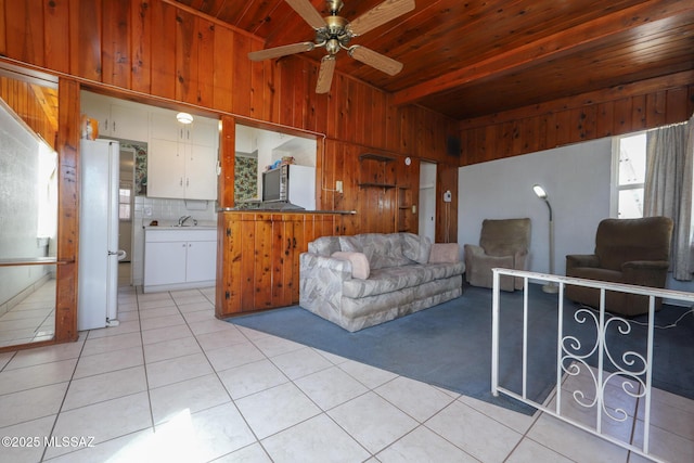 3431 N Edith Blvd, Tucson, AZ 85716 - living area featuring light tile patterned floors, wooden walls, wood ceiling, ceiling fan, and light carpet