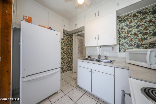 3431 N Edith Blvd, Tucson, AZ 85716 - kitchen featuring white appliances, wallpapered walls, a sink, light countertops, and white cabinets