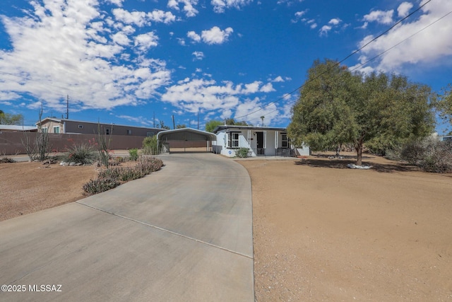 3431 N Edith Blvd, Tucson, AZ 85716 - view of front facade with concrete driveway, a detached carport, and a porch