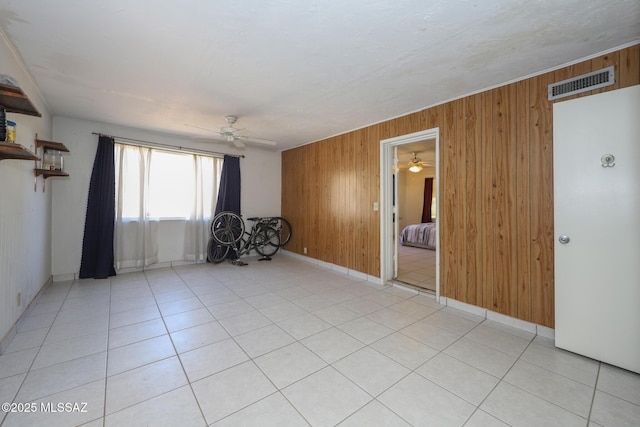 3431 N Edith Blvd, Tucson, AZ 85716 - unfurnished room featuring a ceiling fan, wooden walls, and baseboards