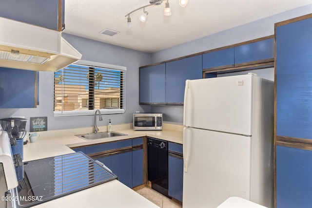 7612 E Callisto Cir Unit 60, Tucson, AZ 85715 - kitchen with freestanding refrigerator, a sink, dishwasher, stainless steel microwave, and under cabinet range hood