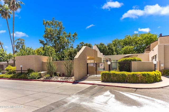 7612 E Callisto Cir Unit 60, Tucson, AZ 85715 - pueblo revival-style home with a fenced front yard and stucco siding
