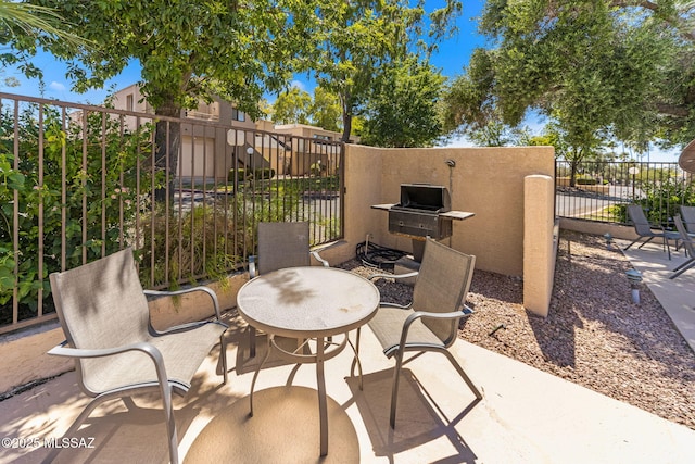 7612 E Callisto Cir Unit 60, Tucson, AZ 85715 - view of patio featuring outdoor dining space and area for grilling