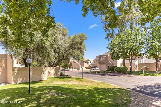 7612 E Callisto Cir Unit 60, Tucson, AZ 85715 - view of asphalt road featuring a residential view, curbs, and street lights
