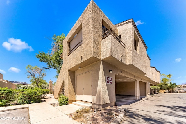 7612 E Callisto Cir Unit 60, Tucson, AZ 85715 - view of front facade with stucco siding and an attached garage