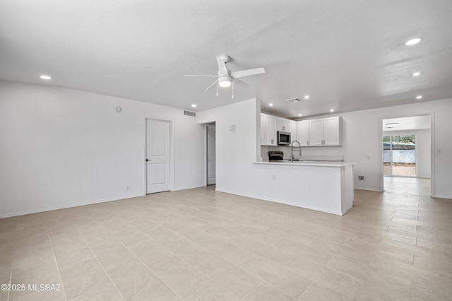 4167 E Los Robles St, Tucson, AZ 85712 - unfurnished living room featuring recessed lighting, ceiling fan, baseboards, and a sink