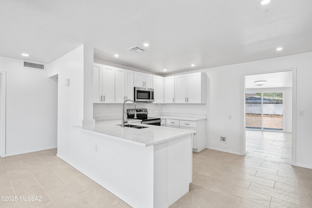 4167 E Los Robles St, Tucson, AZ 85712 - kitchen featuring stainless steel appliances, recessed lighting, light countertops, white cabinetry, and a peninsula