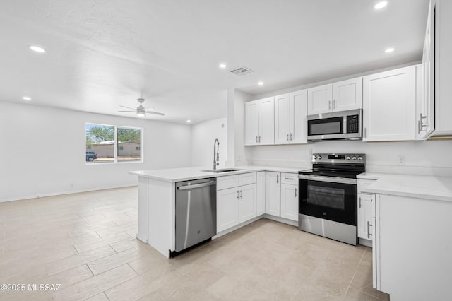 4167 E Los Robles St, Tucson, AZ 85712 - kitchen with stainless steel appliances, a sink, a peninsula, ceiling fan, and light countertops