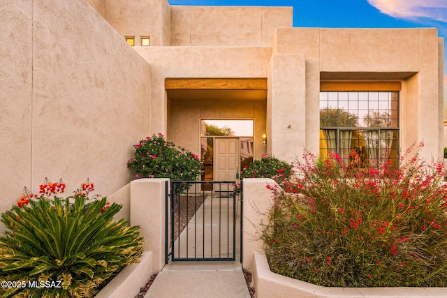 1920 W Canada Hills Dr, Oro Valley, AZ 85737 - view of exterior entry with a gate and stucco siding