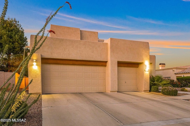 1920 W Canada Hills Dr, Oro Valley, AZ 85737 - southwest-style home with stucco siding, an attached garage, and concrete driveway
