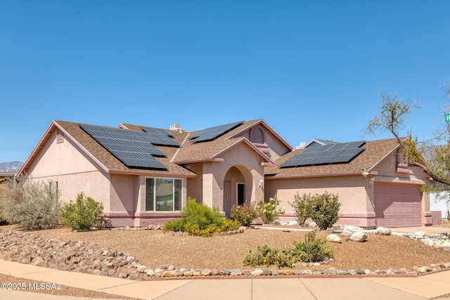 9141 E Bell Cactus Ln, Tucson, AZ 85715 - single story home featuring solar panels, stucco siding, a shingled roof, and a garage