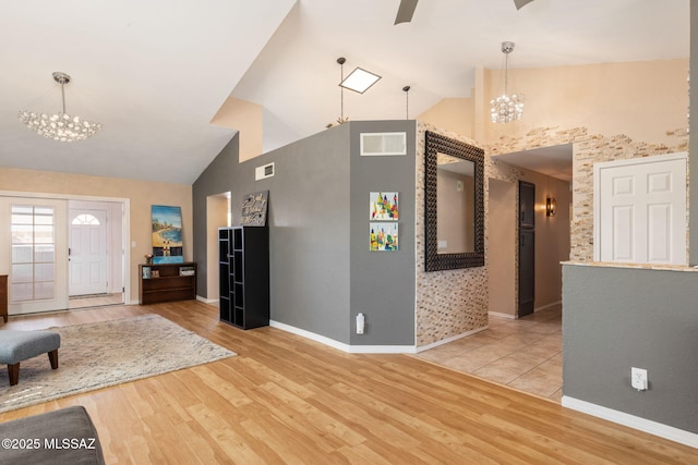 9141 E Bell Cactus Ln, Tucson, AZ 85715 - living room with a chandelier, high vaulted ceiling, wood finished floors, and baseboards