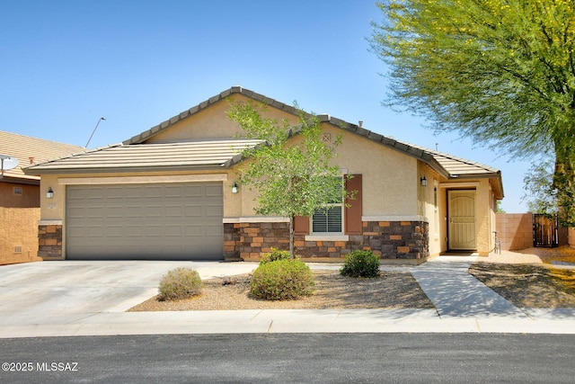 11710 W Boll Bloom Dr, Marana, AZ 85653 - view of front of house featuring stone siding, a garage, driveway, and stucco siding
