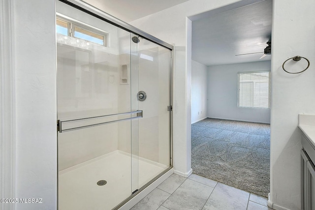 11710 W Boll Bloom Dr, Marana, AZ 85653 - bathroom featuring a shower stall, vanity, a ceiling fan, and tile patterned flooring