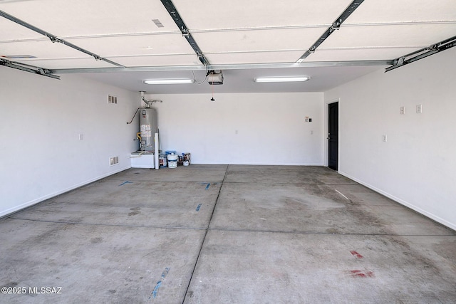 11710 W Boll Bloom Dr, Marana, AZ 85653 - garage with a garage door opener, gas water heater, and baseboards