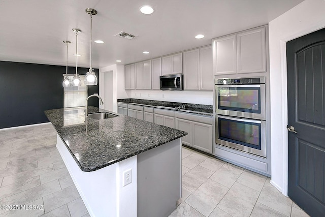 11710 W Boll Bloom Dr, Marana, AZ 85653 - kitchen with appliances with stainless steel finishes, a sink, dark stone counters, recessed lighting, and pendant lighting