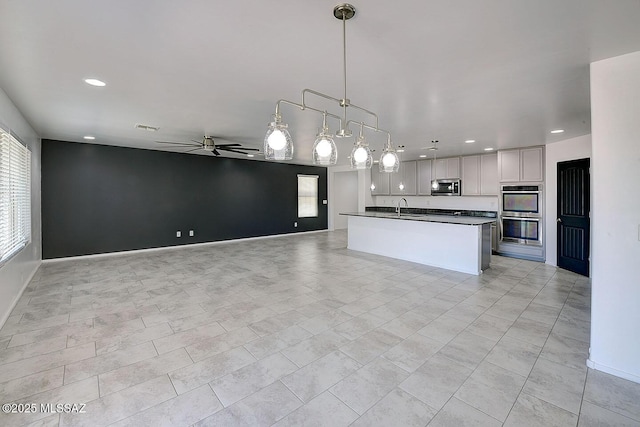 11710 W Boll Bloom Dr, Marana, AZ 85653 - kitchen featuring stainless steel appliances, ceiling fan, open floor plan, dark countertops, and recessed lighting