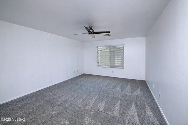 11710 W Boll Bloom Dr, Marana, AZ 85653 - spare room with ceiling fan, dark colored carpet, and baseboards