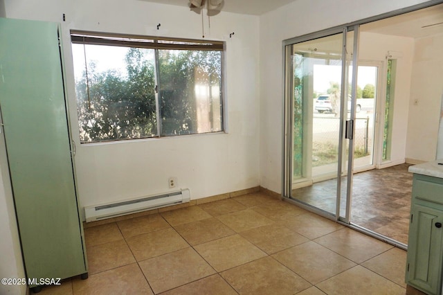100 N Dale Rd, Pearce, AZ 85625 - spare room featuring a baseboard heating unit, plenty of natural light, light tile patterned floors, and ceiling fan