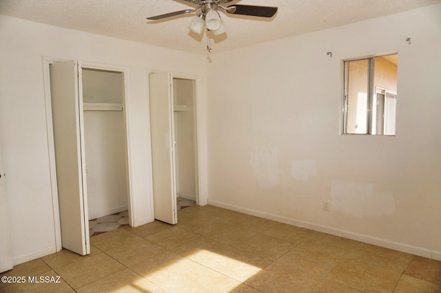 100 N Dale Rd, Pearce, AZ 85625 - unfurnished bedroom featuring multiple closets, light tile patterned floors, a textured ceiling, and baseboards