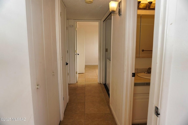 100 N Dale Rd, Pearce, AZ 85625 - corridor featuring light tile patterned floors, a sink, and a textured ceiling