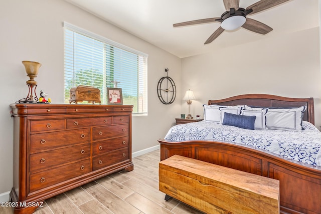 11815 N Silverscape Dr, Oro Valley, AZ 85737 - bedroom featuring baseboards, light wood-style floors, and a ceiling fan