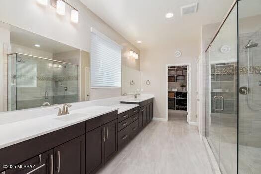 11815 N Silverscape Dr, Oro Valley, AZ 85737 - full bathroom with double vanity, a stall shower, and baseboards