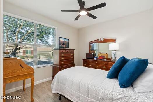 11815 N Silverscape Dr, Oro Valley, AZ 85737 - bedroom with baseboards, light wood finished floors, and a ceiling fan