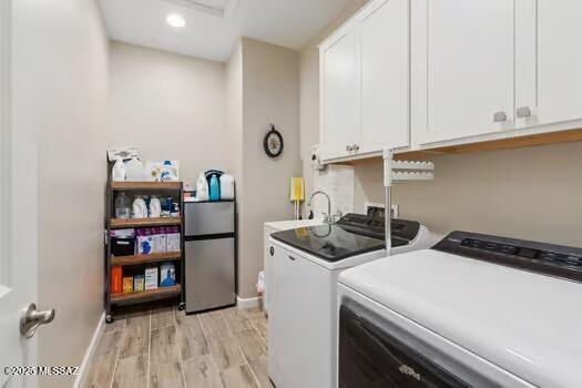 11815 N Silverscape Dr, Oro Valley, AZ 85737 - laundry area with cabinet space, washer and dryer, light wood-style flooring, baseboards, and recessed lighting