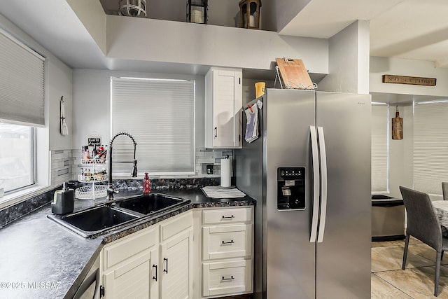 9650 N Gyor Pl, Tucson, AZ 85742 - kitchen featuring stainless steel fridge, a sink, white cabinets, dark countertops, and light tile patterned floors