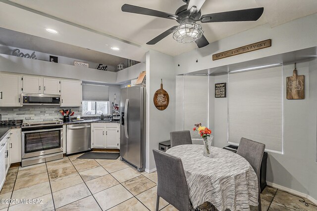 9650 N Gyor Pl, Tucson, AZ 85742 - kitchen featuring appliances with stainless steel finishes, dark countertops, white cabinetry, ceiling fan, and recessed lighting