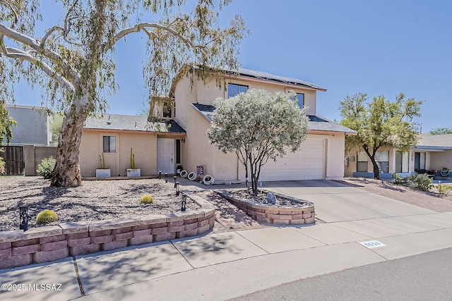 9650 N Gyor Pl, Tucson, AZ 85742 - obstructed view of property featuring driveway, stucco siding, solar panels, and an attached garage