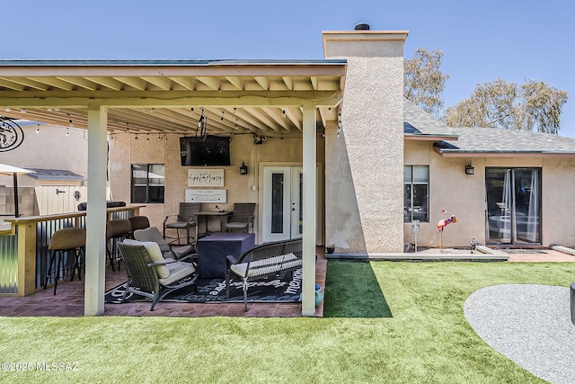 9650 N Gyor Pl, Tucson, AZ 85742 - rear view of house with stucco siding, a patio area, a chimney, a lawn, and roof with shingles