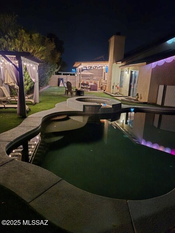 9650 N Gyor Pl, Tucson, AZ 85742 - pool at twilight featuring a patio and a pool with connected hot tub