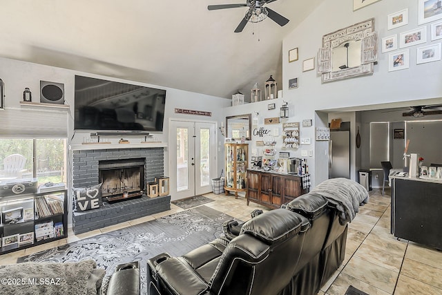 9650 N Gyor Pl, Tucson, AZ 85742 - tiled living area featuring ceiling fan, high vaulted ceiling, a brick fireplace, and french doors