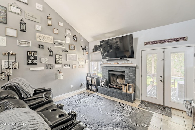 9650 N Gyor Pl, Tucson, AZ 85742 - living area featuring tile patterned flooring, vaulted ceiling, a brick fireplace, baseboards, and french doors