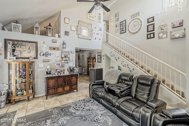9650 N Gyor Pl, Tucson, AZ 85742 - tiled living room featuring ceiling fan, stairs, high vaulted ceiling, and baseboards
