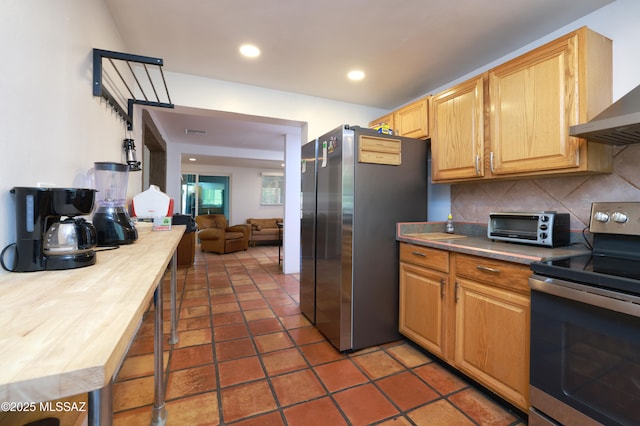 2931 N Mitch Dr, Tucson, AZ 85719 - kitchen featuring appliances with stainless steel finishes, wall chimney exhaust hood, decorative backsplash, recessed lighting, and wood counters