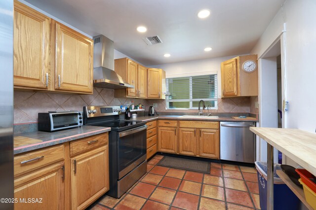 2931 N Mitch Dr, Tucson, AZ 85719 - kitchen with appliances with stainless steel finishes, wall chimney range hood, a sink, decorative backsplash, and recessed lighting