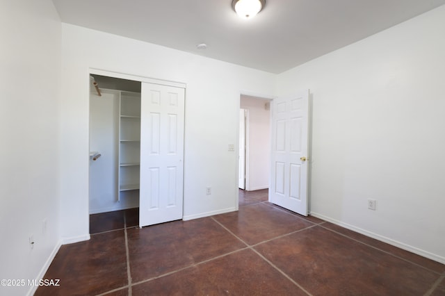 2931 N Mitch Dr, Tucson, AZ 85719 - unfurnished bedroom featuring baseboards, concrete flooring, and a closet
