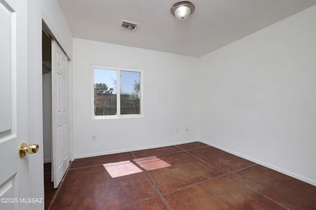 2931 N Mitch Dr, Tucson, AZ 85719 - unfurnished bedroom with concrete flooring, baseboards, and a closet