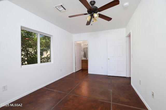 2931 N Mitch Dr, Tucson, AZ 85719 - unfurnished bedroom featuring baseboards, concrete floors, and connected bathroom