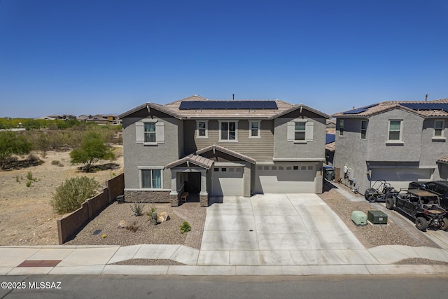 5550 S Sycamore Rim Trl, Tucson, AZ 85747 - view of front of home with an attached garage, stucco siding, a tile roof, solar panels, and concrete driveway