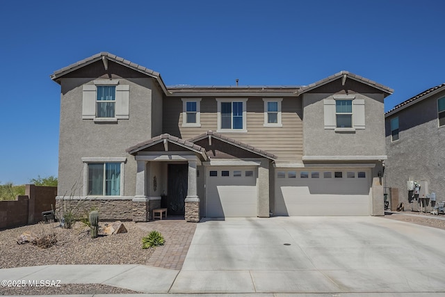 5550 S Sycamore Rim Trl, Tucson, AZ 85747 - view of front of home with a garage, concrete driveway, stucco siding, solar panels, and stone siding