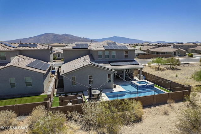5550 S Sycamore Rim Trl, Tucson, AZ 85747 - rear view of house featuring a fenced backyard, roof mounted solar panels, a residential view, and a mountain view