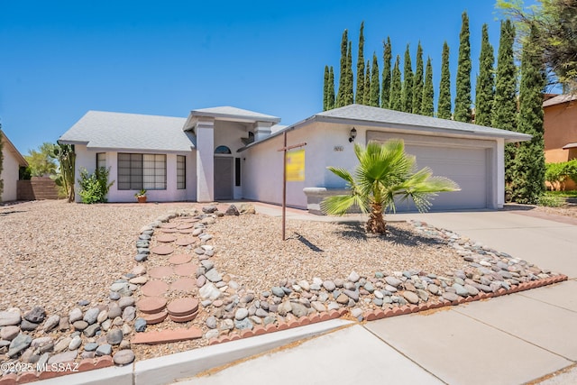 9701 N Camino Del Fierro, Tucson, AZ 85742 - ranch-style home featuring driveway, an attached garage, and stucco siding