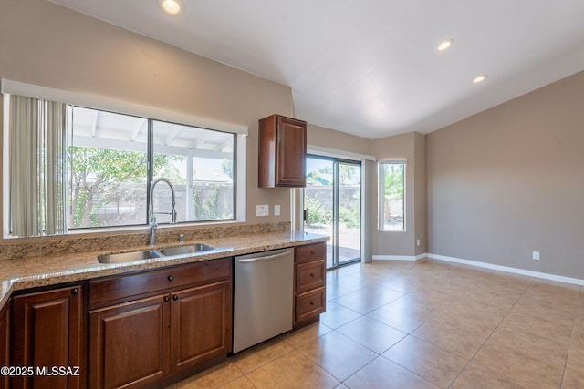 9701 N Camino Del Fierro, Tucson, AZ 85742 - kitchen with stainless steel dishwasher, a sink, light tile patterned flooring, light stone countertops, and baseboards